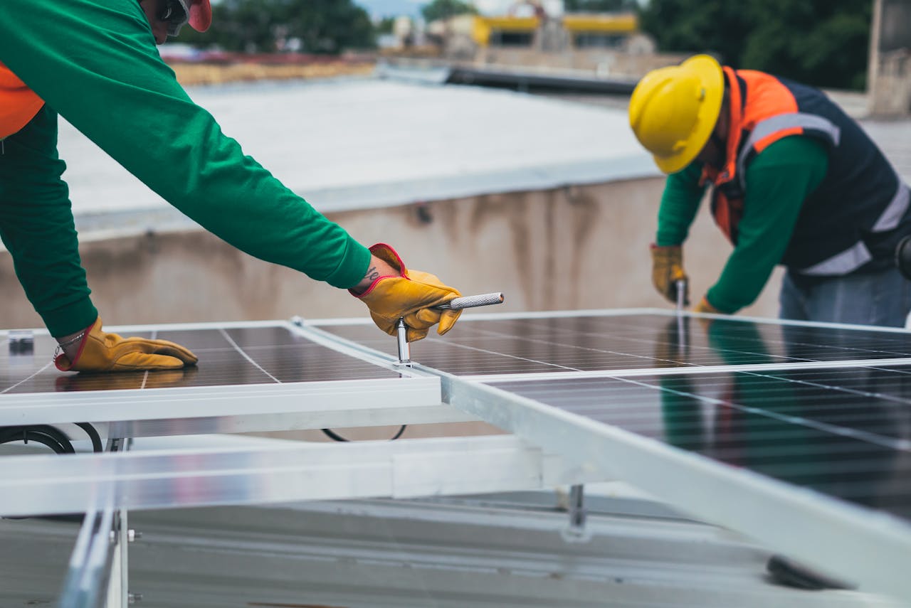 services-img Workers secure solar panels on a rooftop, advancing renewable energy.