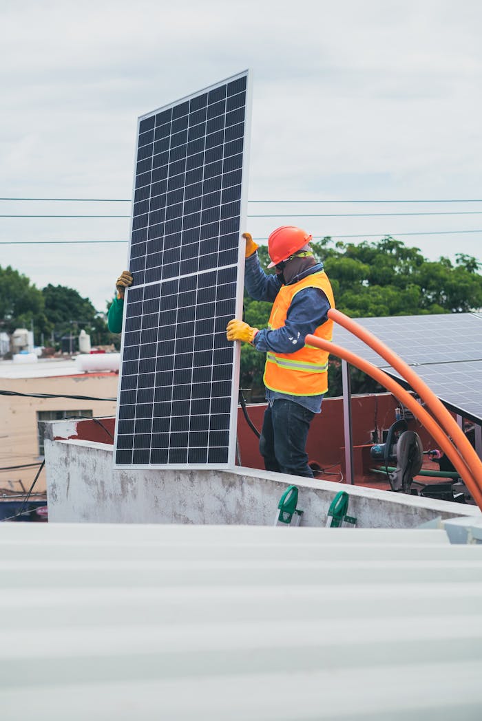 services-03 A technician in safety gear installs a solar panel on a rooftop, promoting renewable energy.